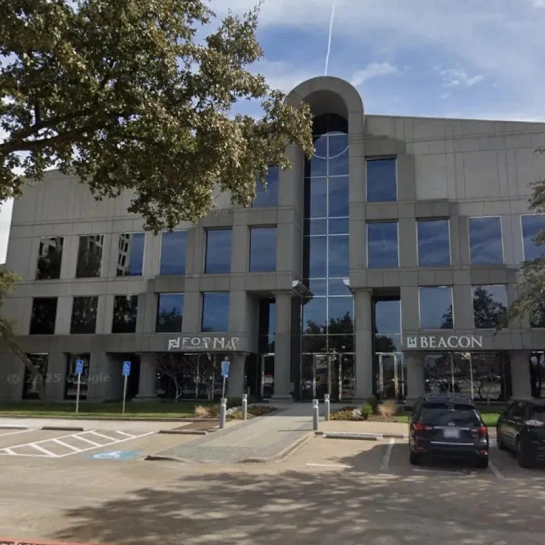 Modern orthodontics office building with glass entrance and blue-trimmed windows in urban plaza setting.